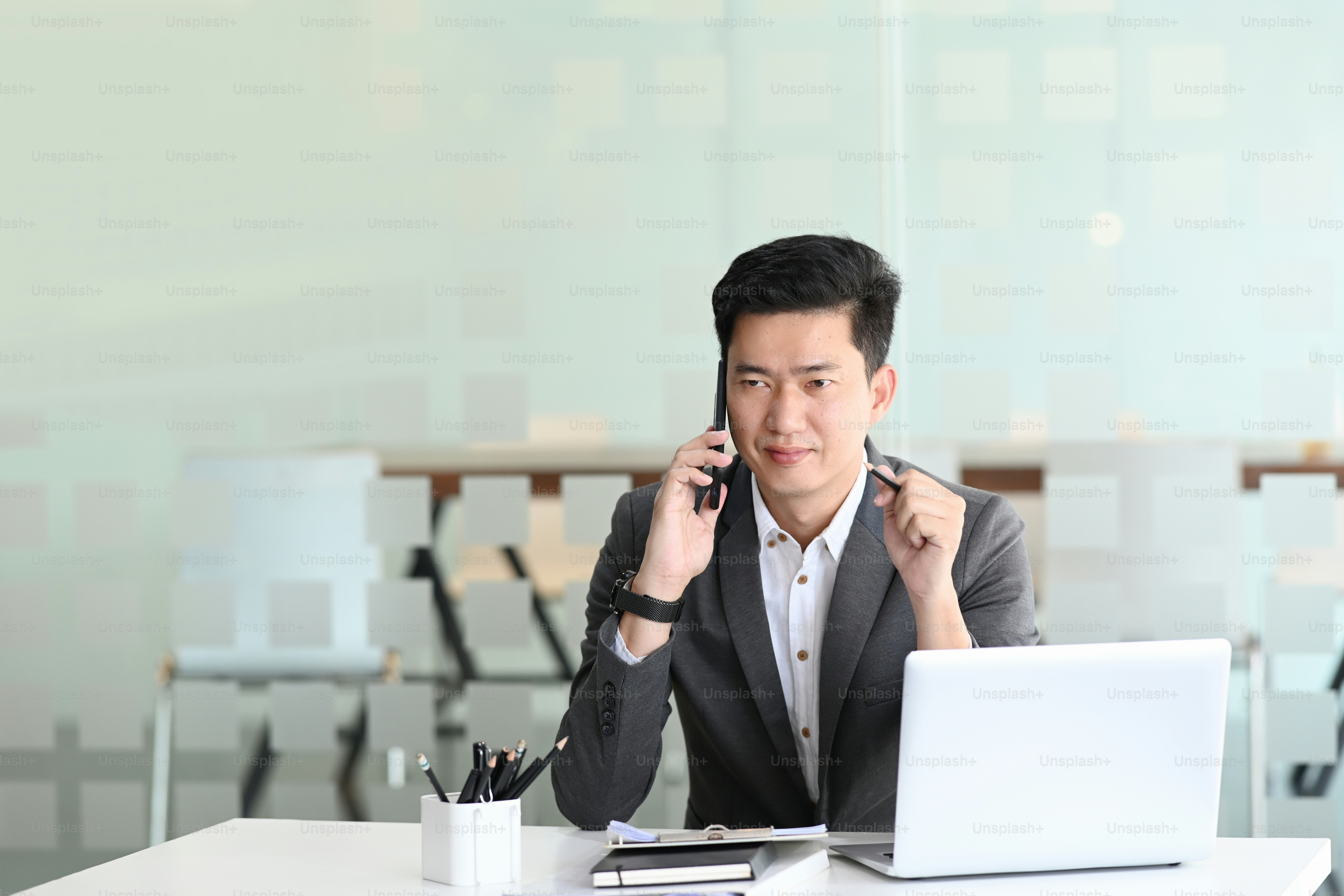 Portrait of handsome businessman in a phone call talking and explaining ...