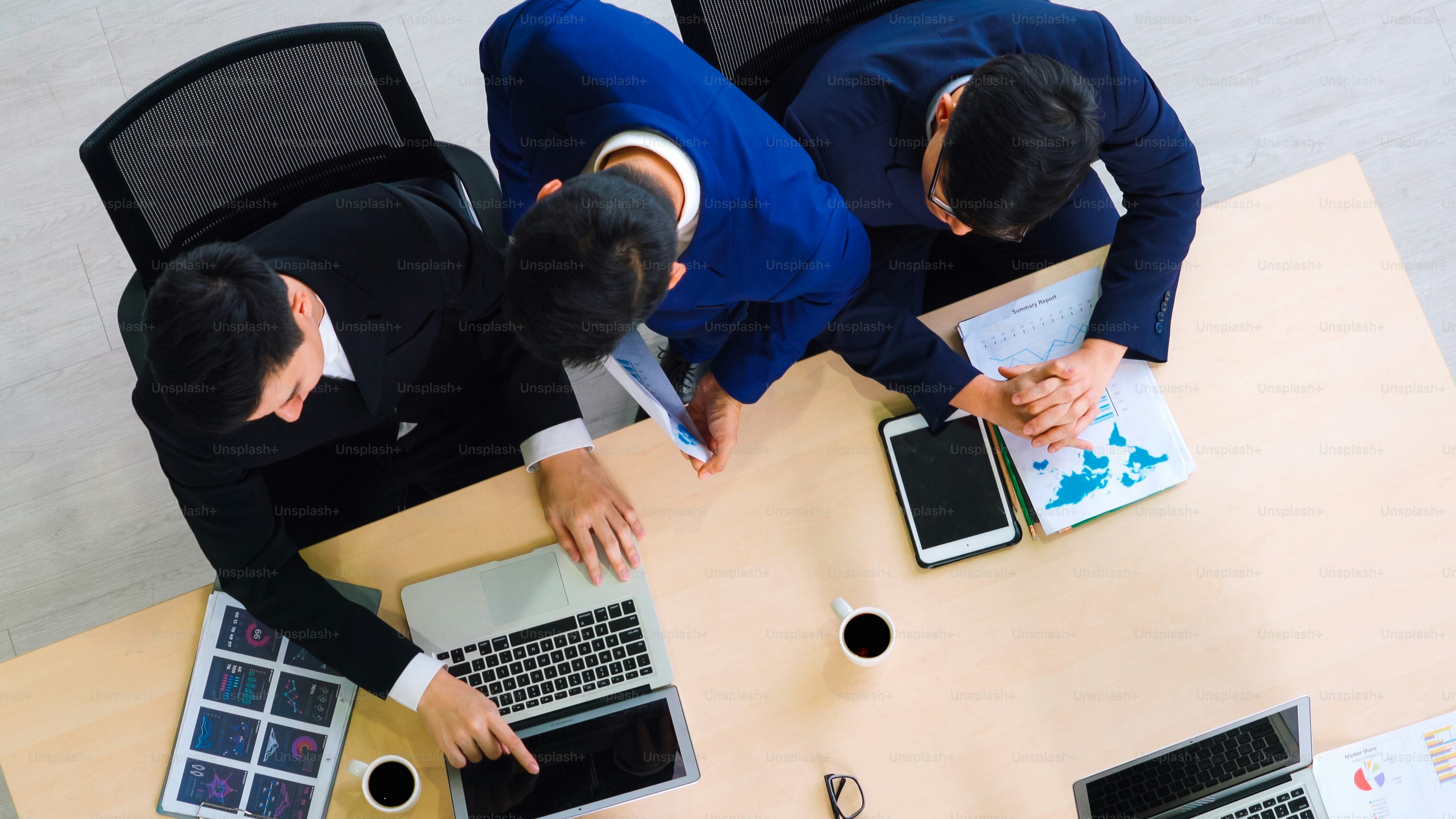 Business people group meeting shot from top view in office . Profession businesswomen, businessmen and office workers working in team conference with project planning document on meeting table .