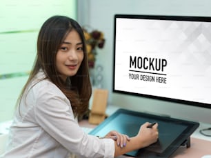 Portrait of businesswoman working with drawing tablet and computer include clipping path in office room