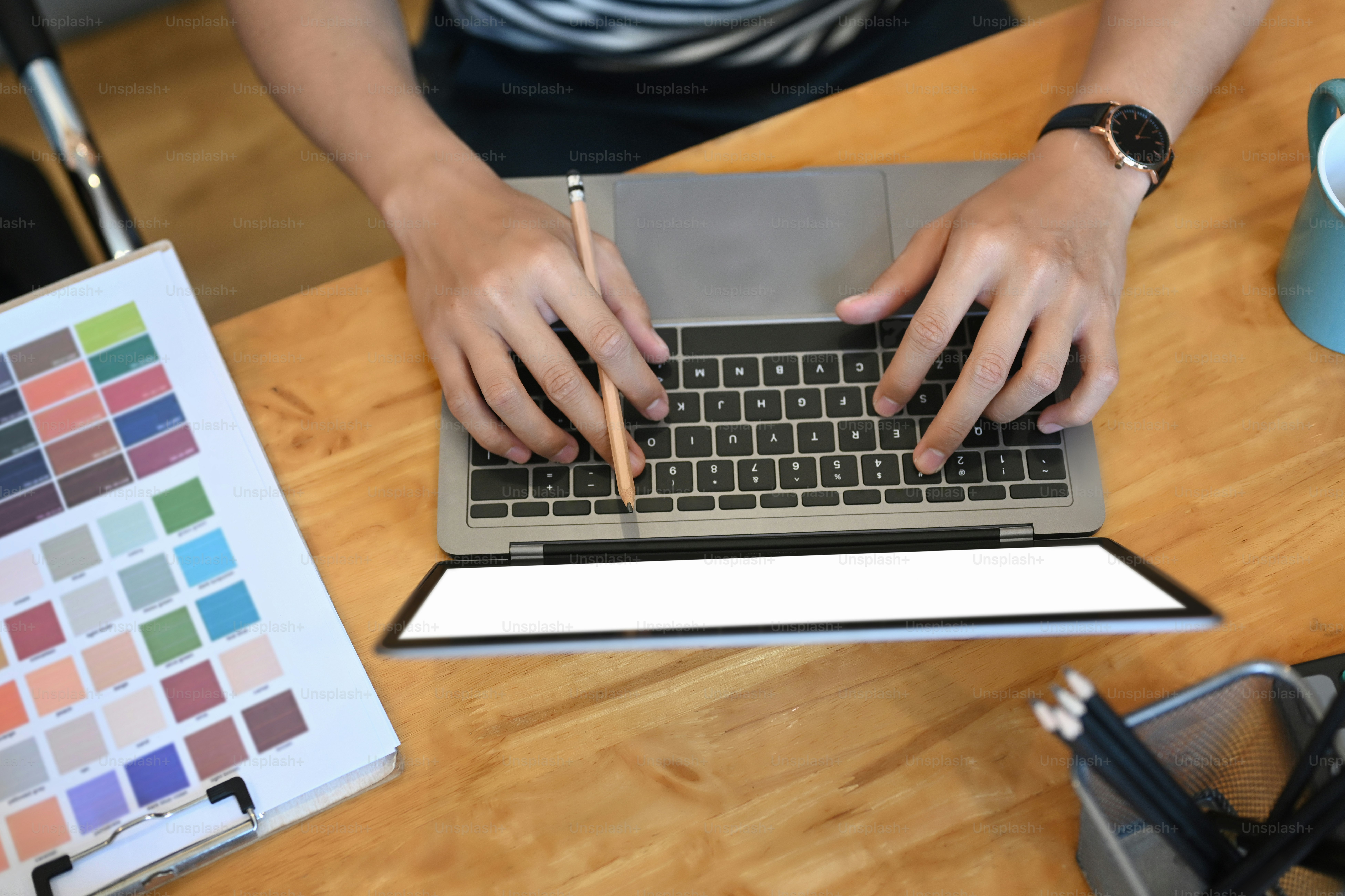 Overhead shot of young man designer working with laptop computer and ...