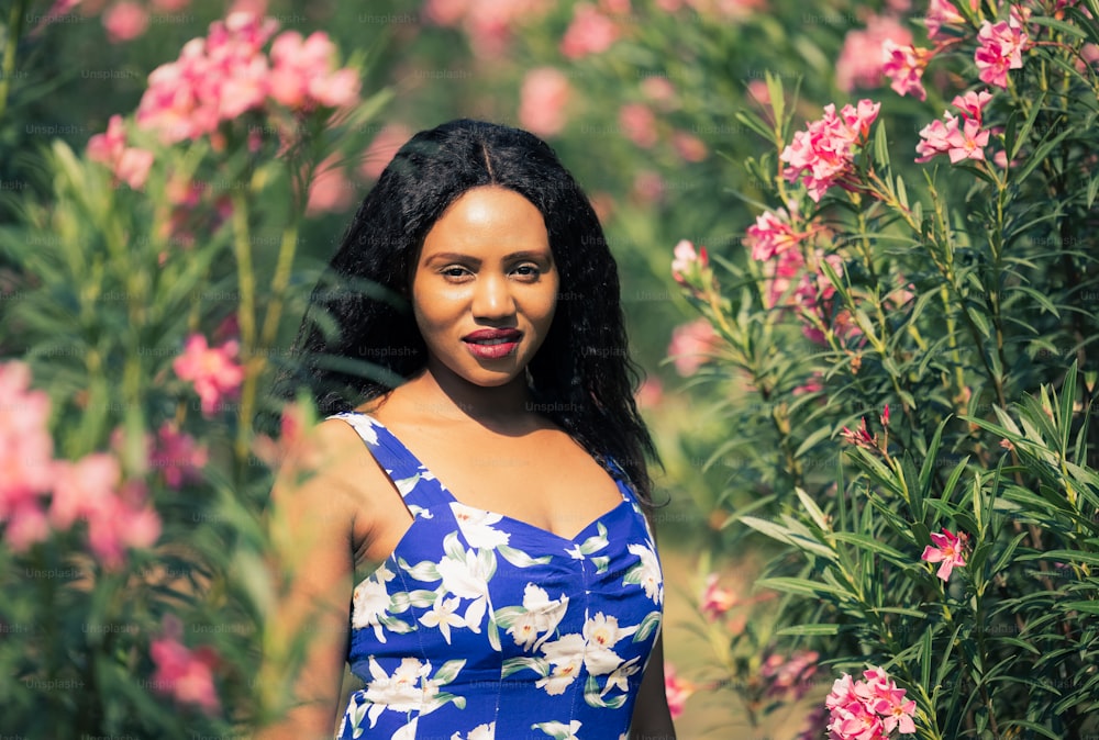 Content Black Woman Smelling Flowers in Park