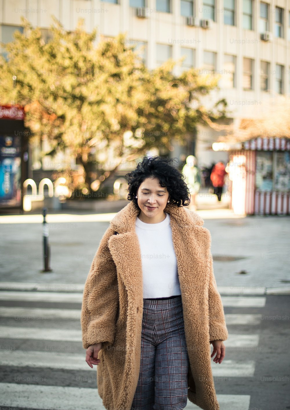 Smiling Woman crossing the road.