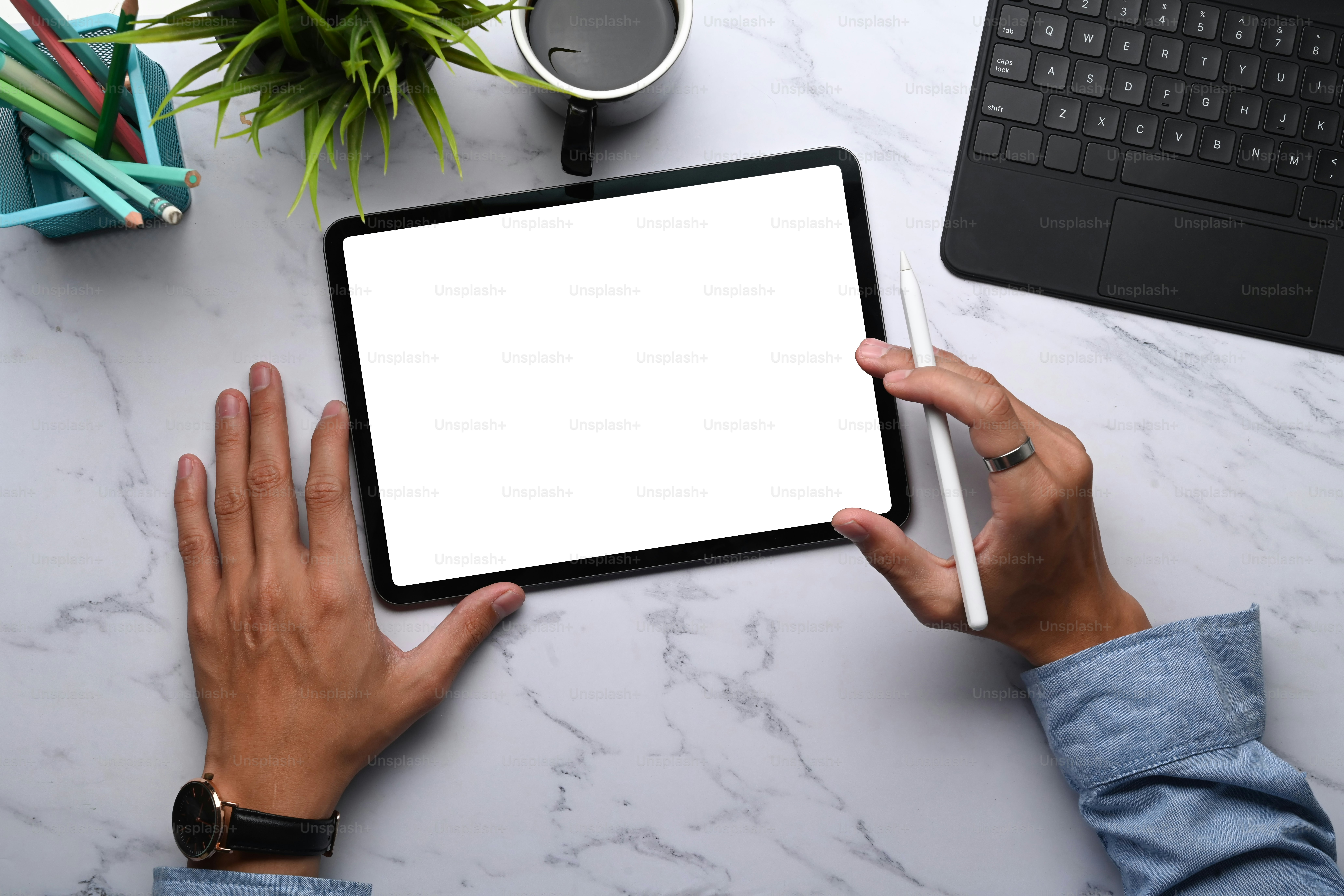 Overhead shot of young man graphic designer holding stylus pen and digital  tablet with blank screen on marble table. photo – Technology Image on  Unsplash