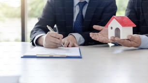 Businessman signing of investment and real estate contract.