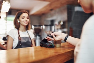 Young female cafe worker indoors. Conception of business and service.