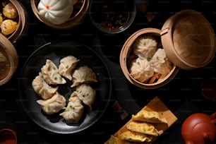 Top view of Dimsum on plate and bamboo steamer with dumplings and pork buns in Chinese restaurant