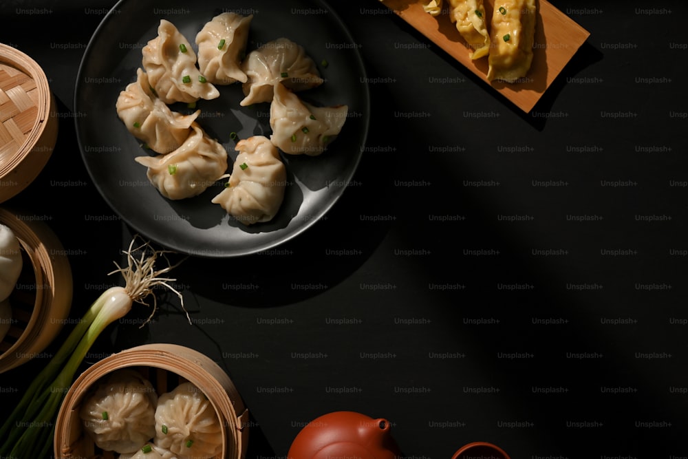 Top view of the table with Dimsum dumplings, tea pot and copy space in restaurant