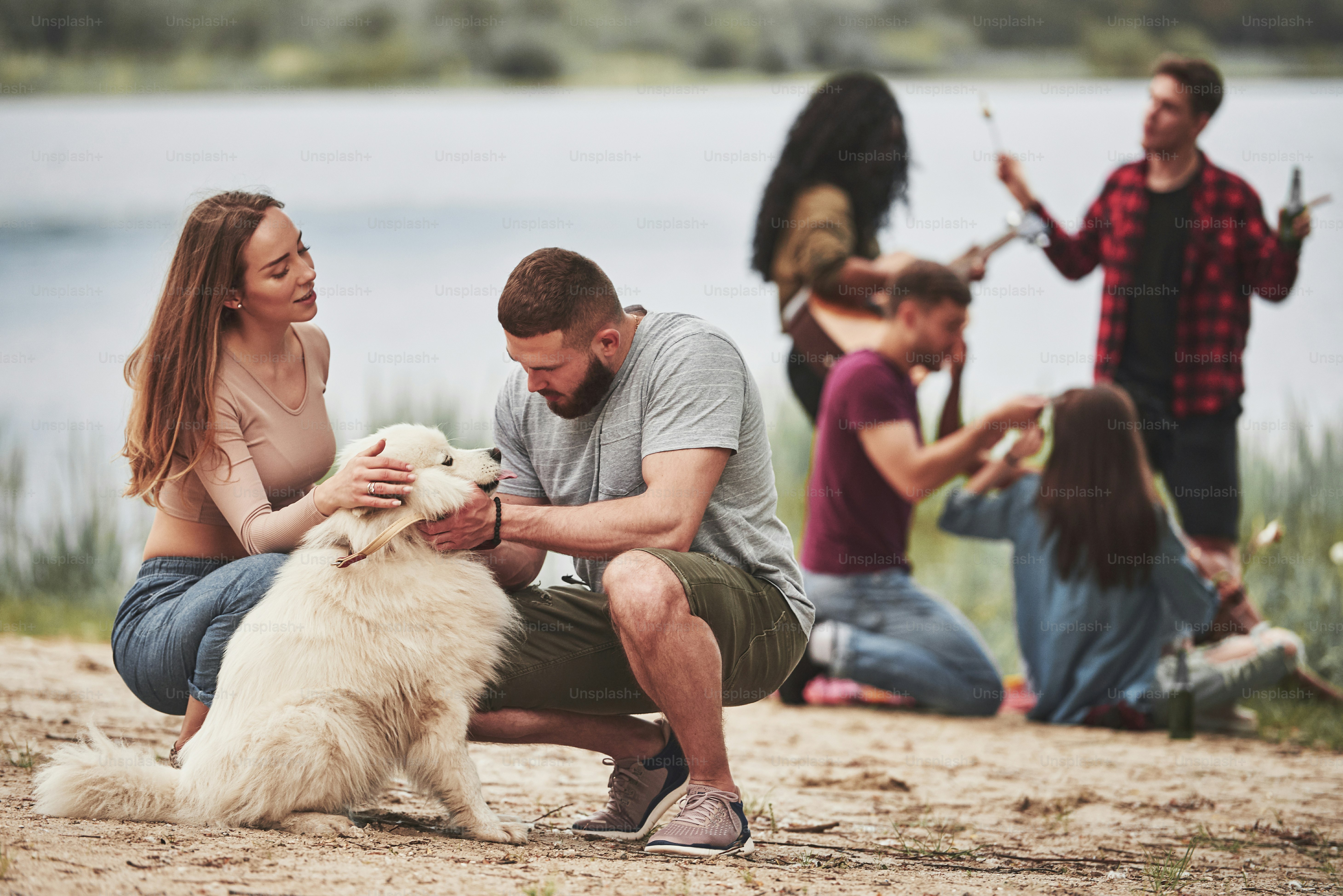 Give me look at you. Group of people have picnic on the beach. Friends have fun at weekend time.