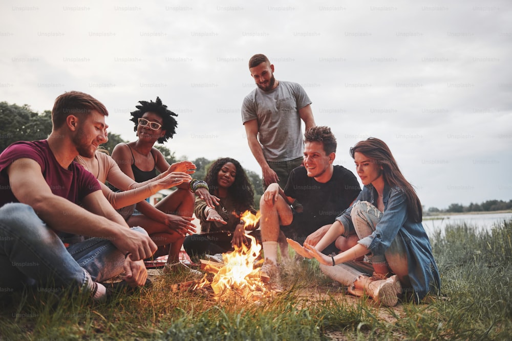 Summer beach party. Group of people have picnic. Friends have fun at weekend time.