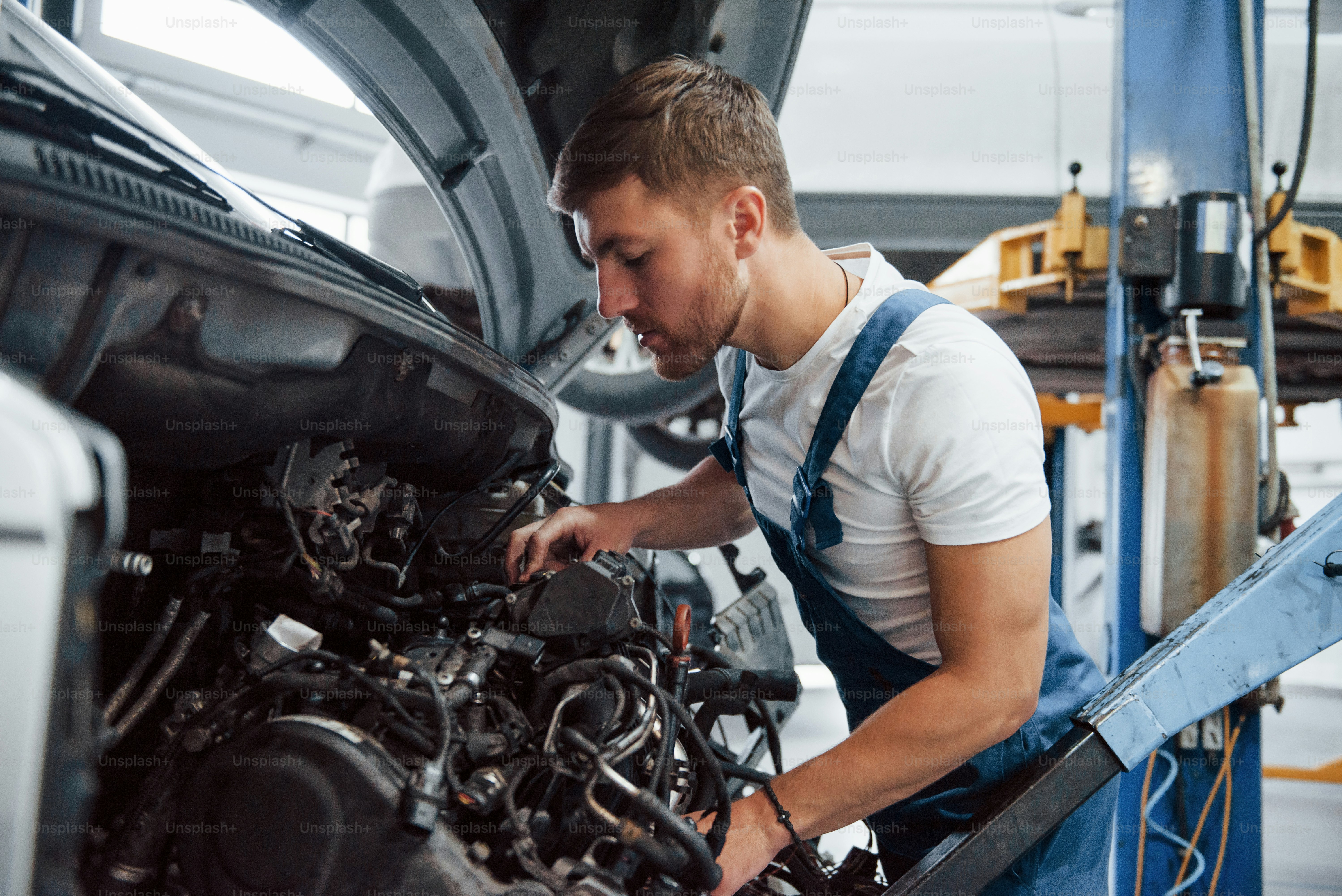 Inside of the car. Employee in the blue colored uniform works in the ...