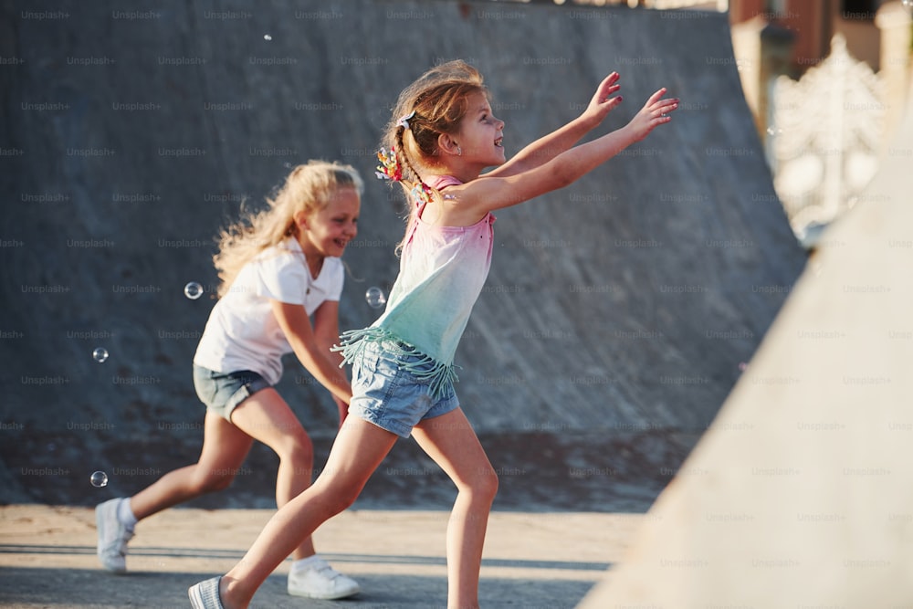 Having fun with bubbles. Leisure activities. Two little girls having fun in the park.