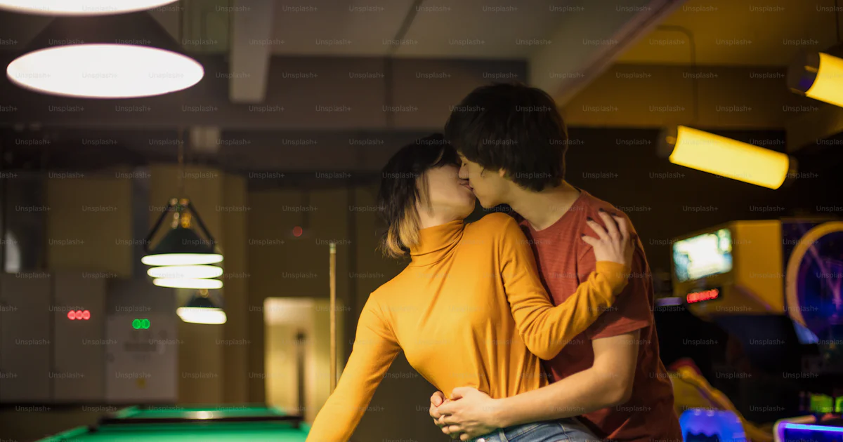 The Couple Is Kissing In The Billiard Room Couple In Playroom Photo the-couple-is-kissing-in-the-billiard-room-couple-in-playroom-photo