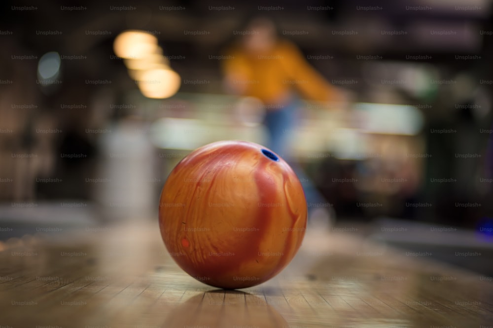 Femme jouant au bowling. L’accent est mis sur le lanceur.