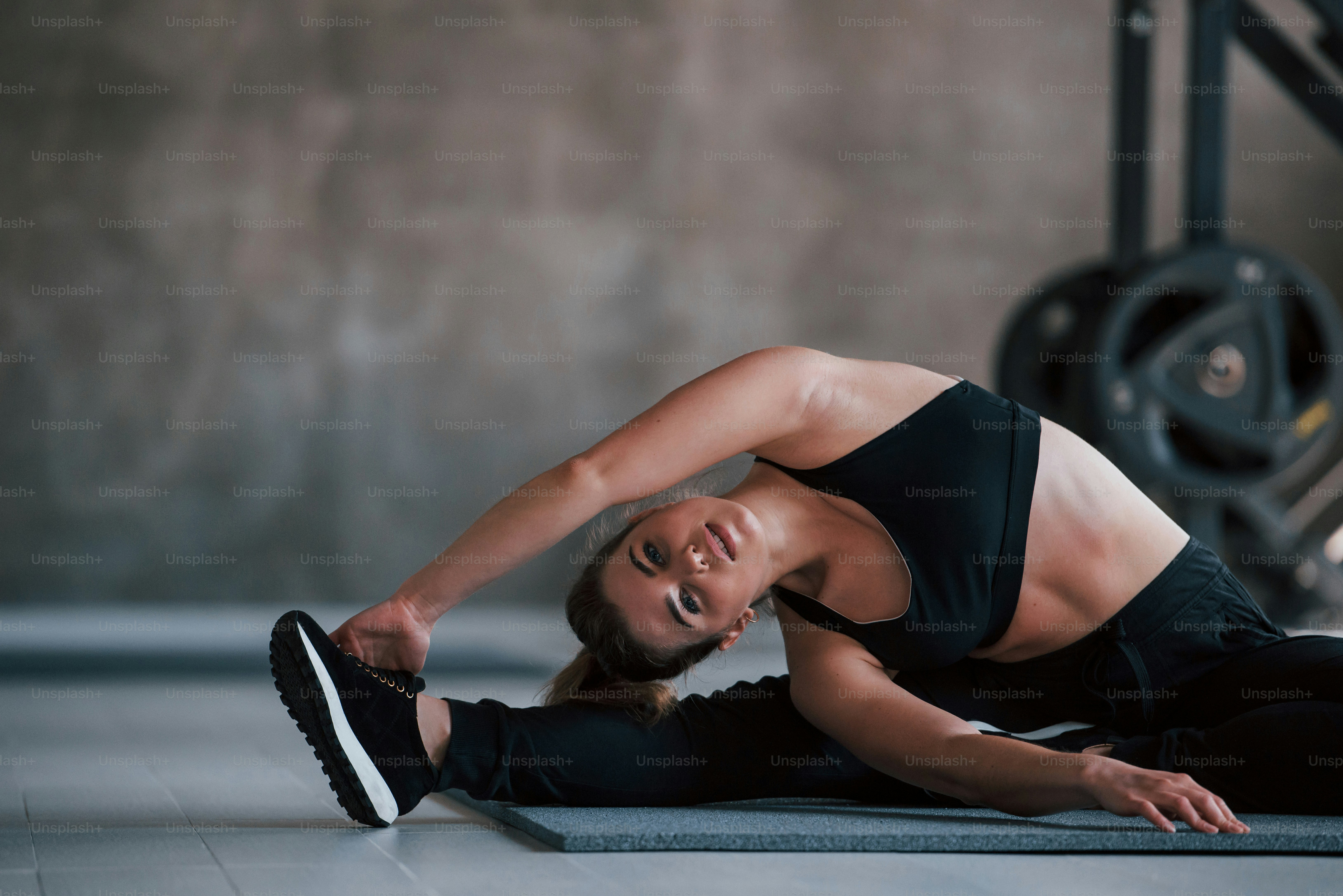 Nice flexibility. Photo of gorgeous blonde woman in the gym at her weekend time.