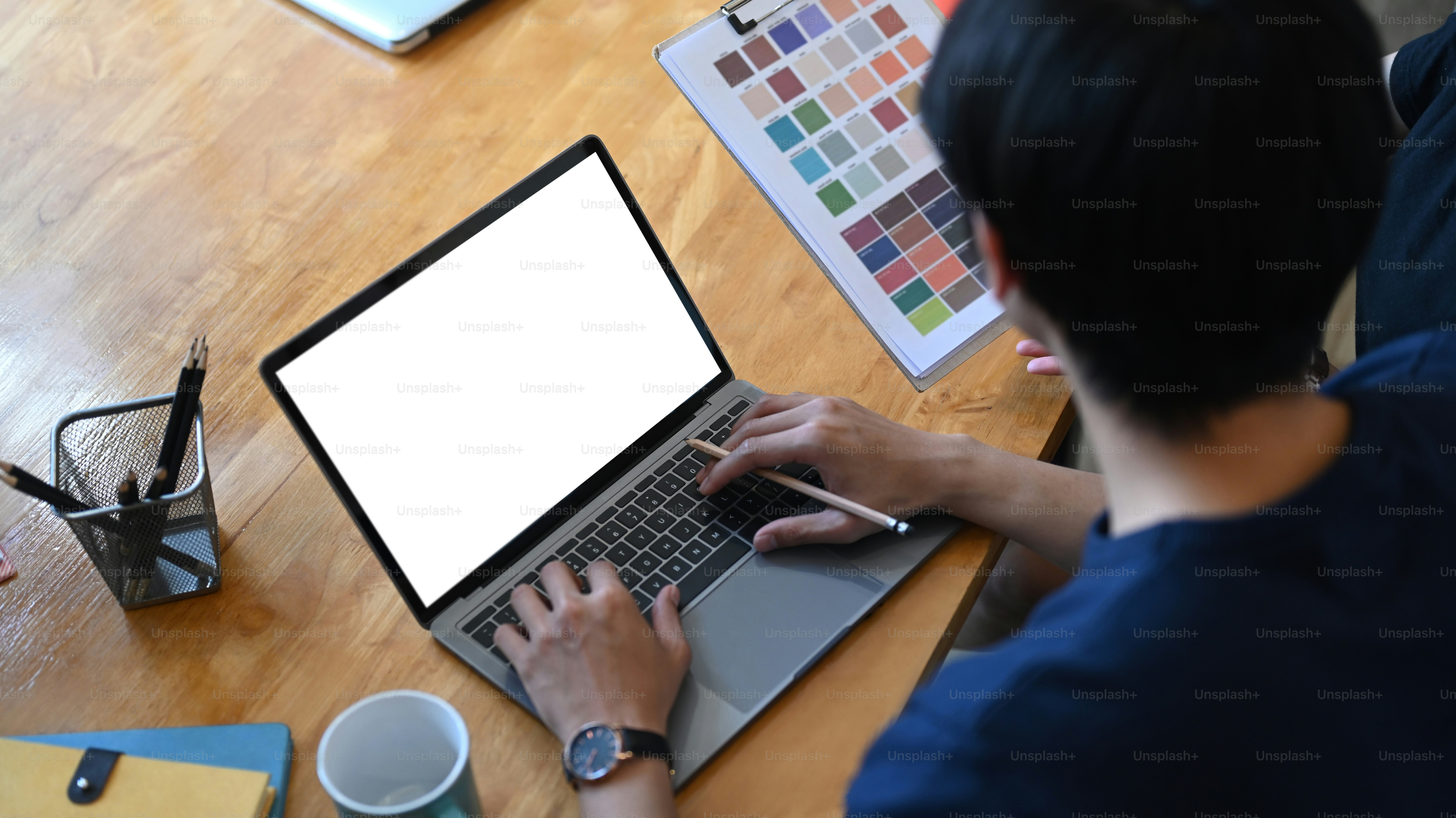 Rear view of young man graphic designer working on computer laptop at ...