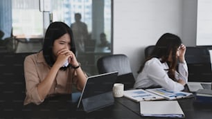 Two serious business women colleagues having disagreement  in office.