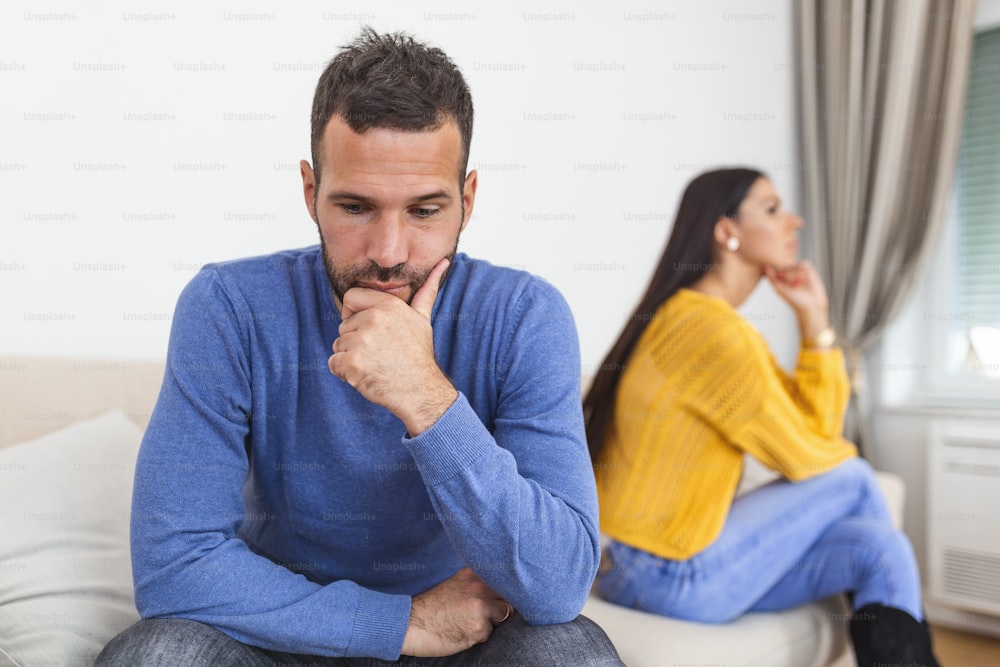 People, relationship difficulties, conflict and family concept - Unhappy couple having argument at home. Couple Having Argument At Home. Troubled woman expressing despair