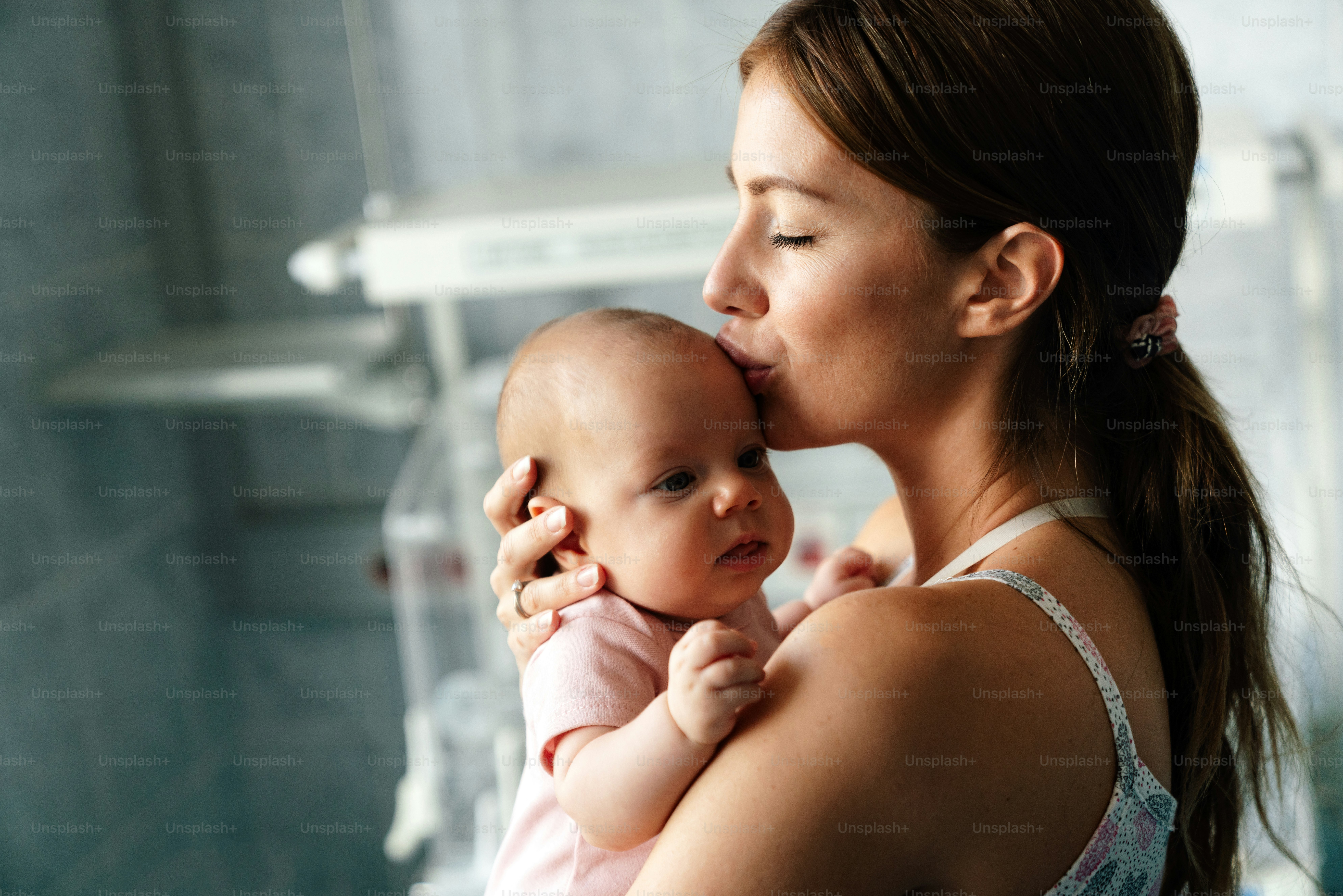 Happy cheerful family. Mother and baby kissing, laughing and hugging together