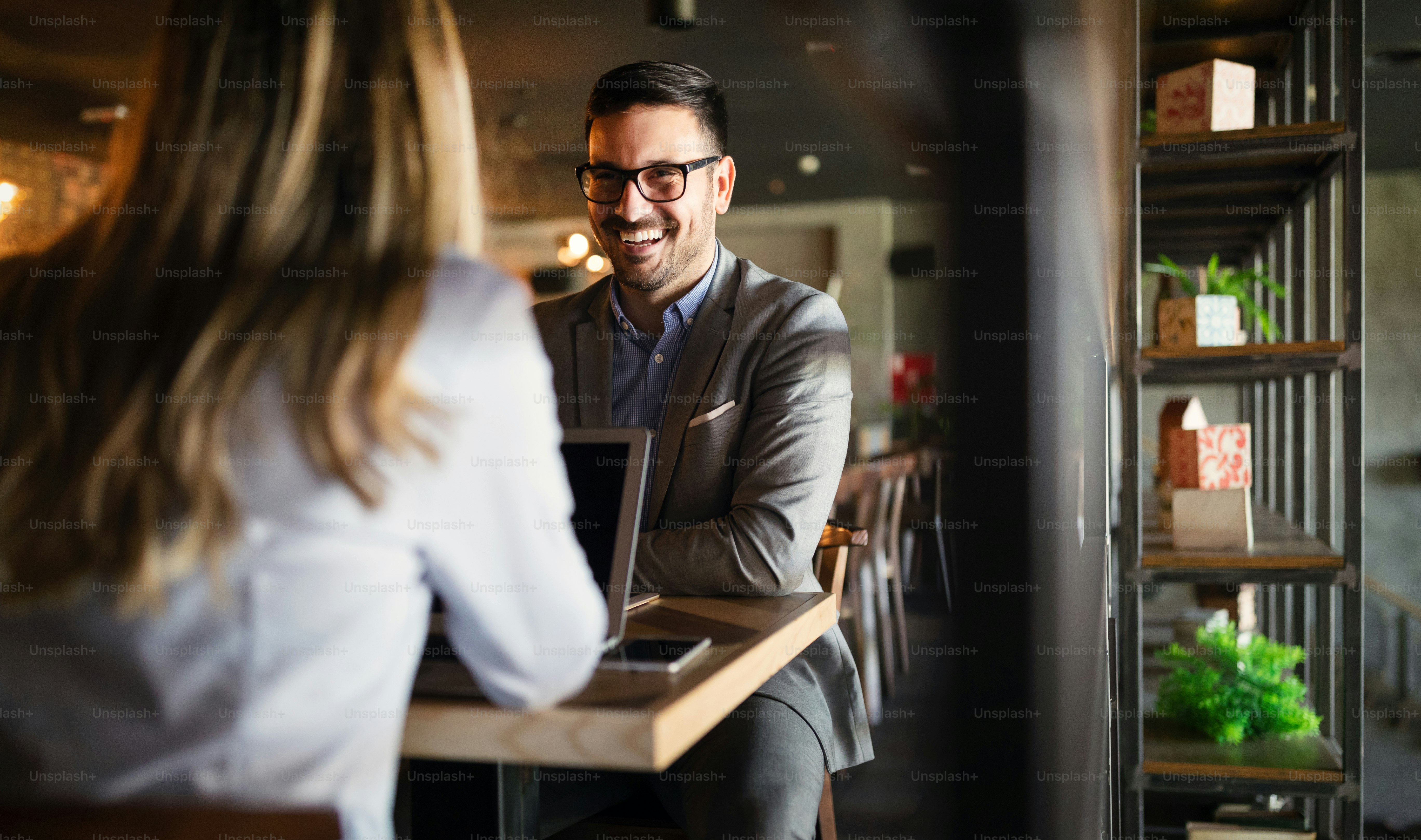 Startup business team on meeting in modern office interior brainstorming, working on laptop and tablet computer