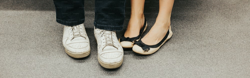 Closeup of man and woman legs in outdoor shoes together. Couple dating sitting together. Love and romance. Romantic dating. Details and body parts. Web banner header.