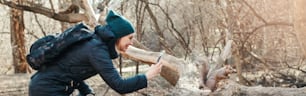 Woman taking picture photo of squirrel in park. Tourist traveler girl snapping smartphone photos of wild animal in forest. Fun outdoor activity and blogging vlogging online. Web banner header.