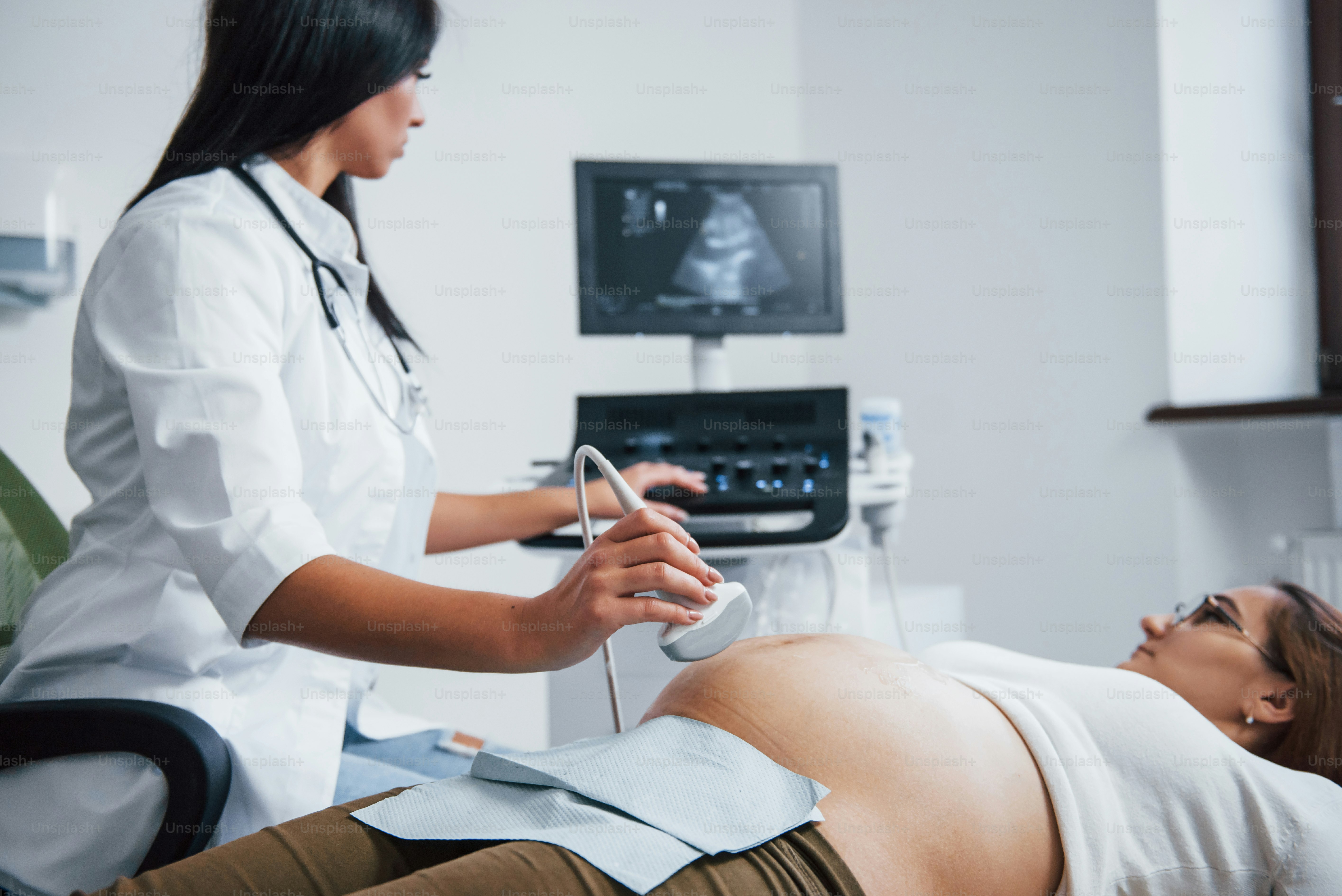Female doctor does ultrasound for a pregnant woman in the hospital.