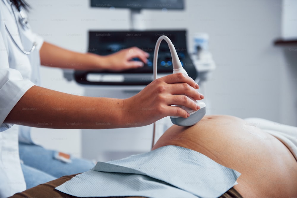 Female doctor does ultrasound for a pregnant woman in the hospital.