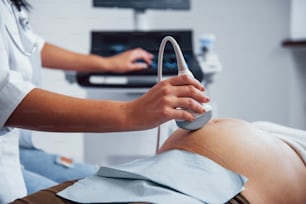 Female doctor does ultrasound for a pregnant woman in the hospital.