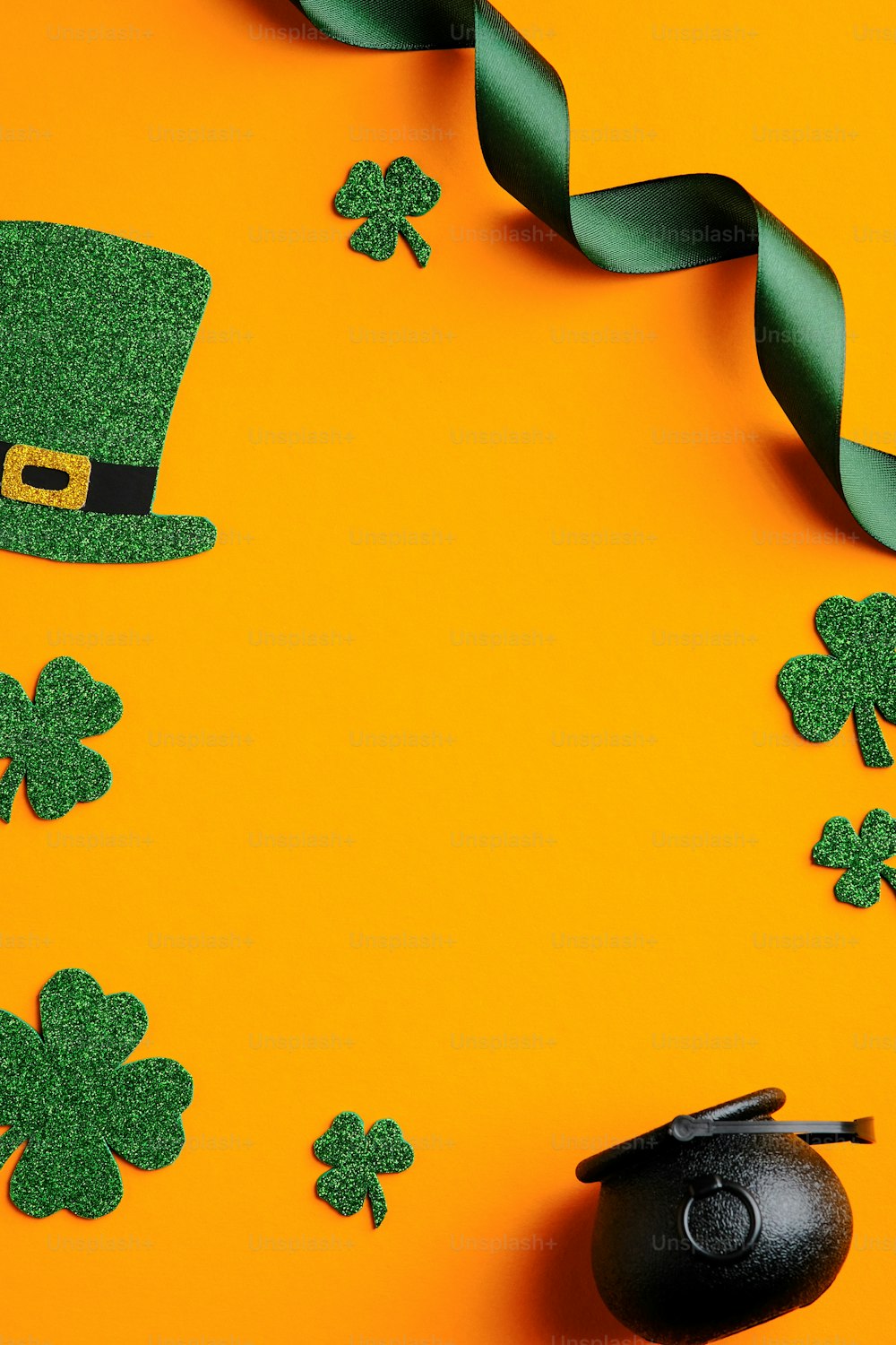 St Patricks day banner design. Top view pot of gold, shamrock leaves, leprechaun hat on orange background. Saint Patrick's day greeting card template.