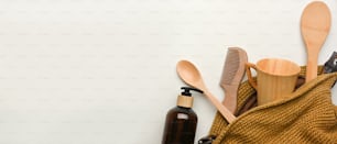 Zero waste concept, mock up scene with wooden kitchenware in wicker bag and copy space on white background