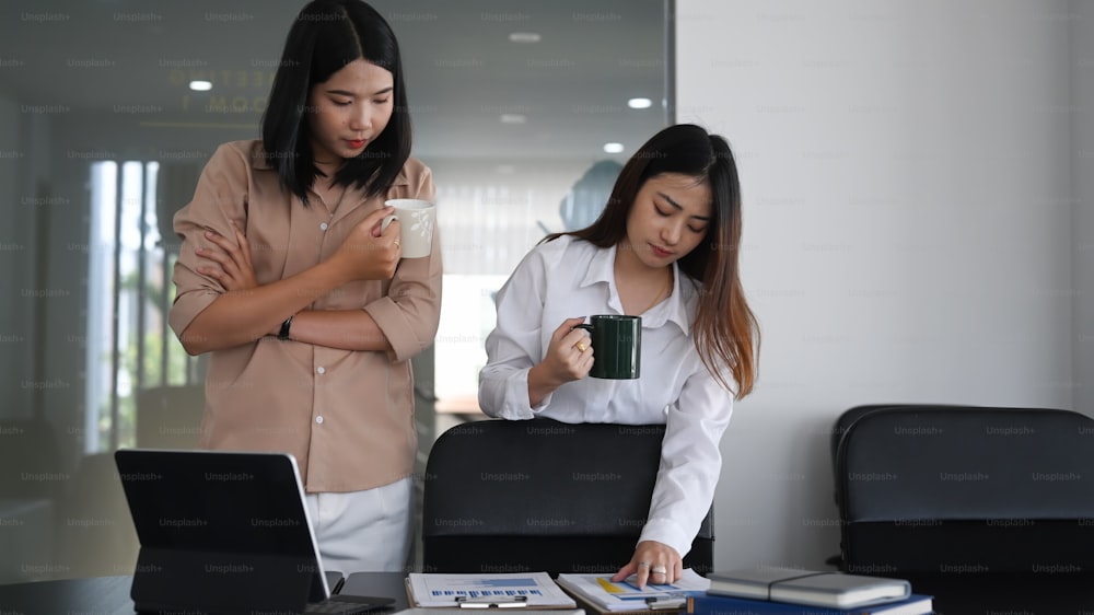 Two businesswoman working together in trendy office space.