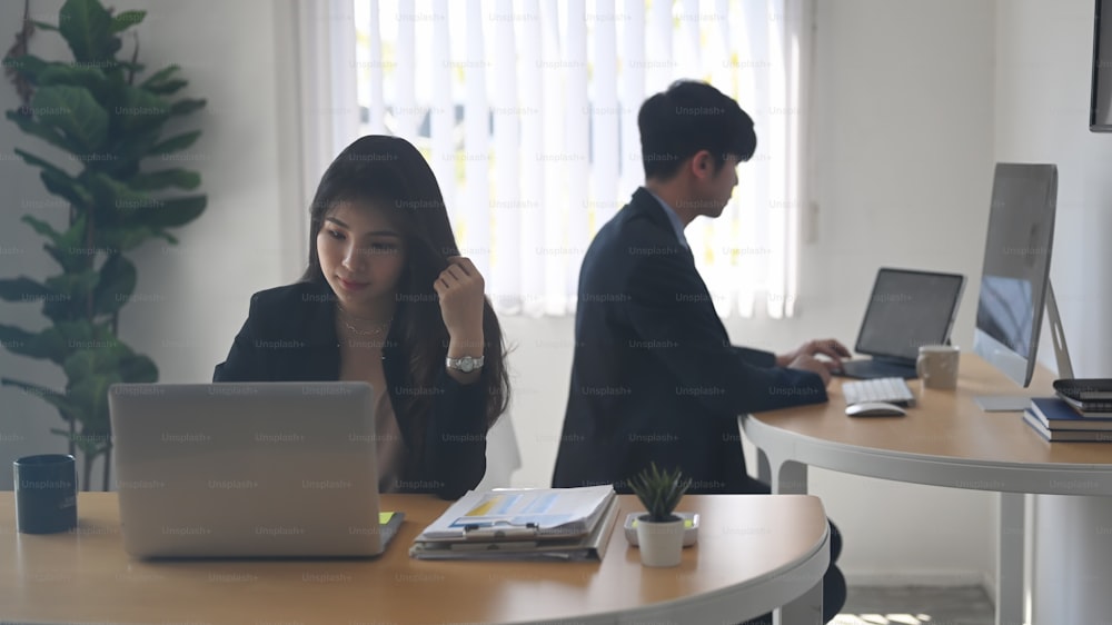 Two young business people working together in an office.