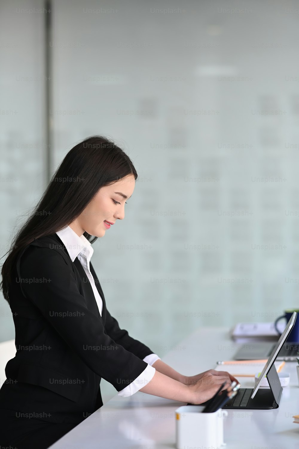 Side view of attractive businesswoman concentrate working on computer tablet at modern office.