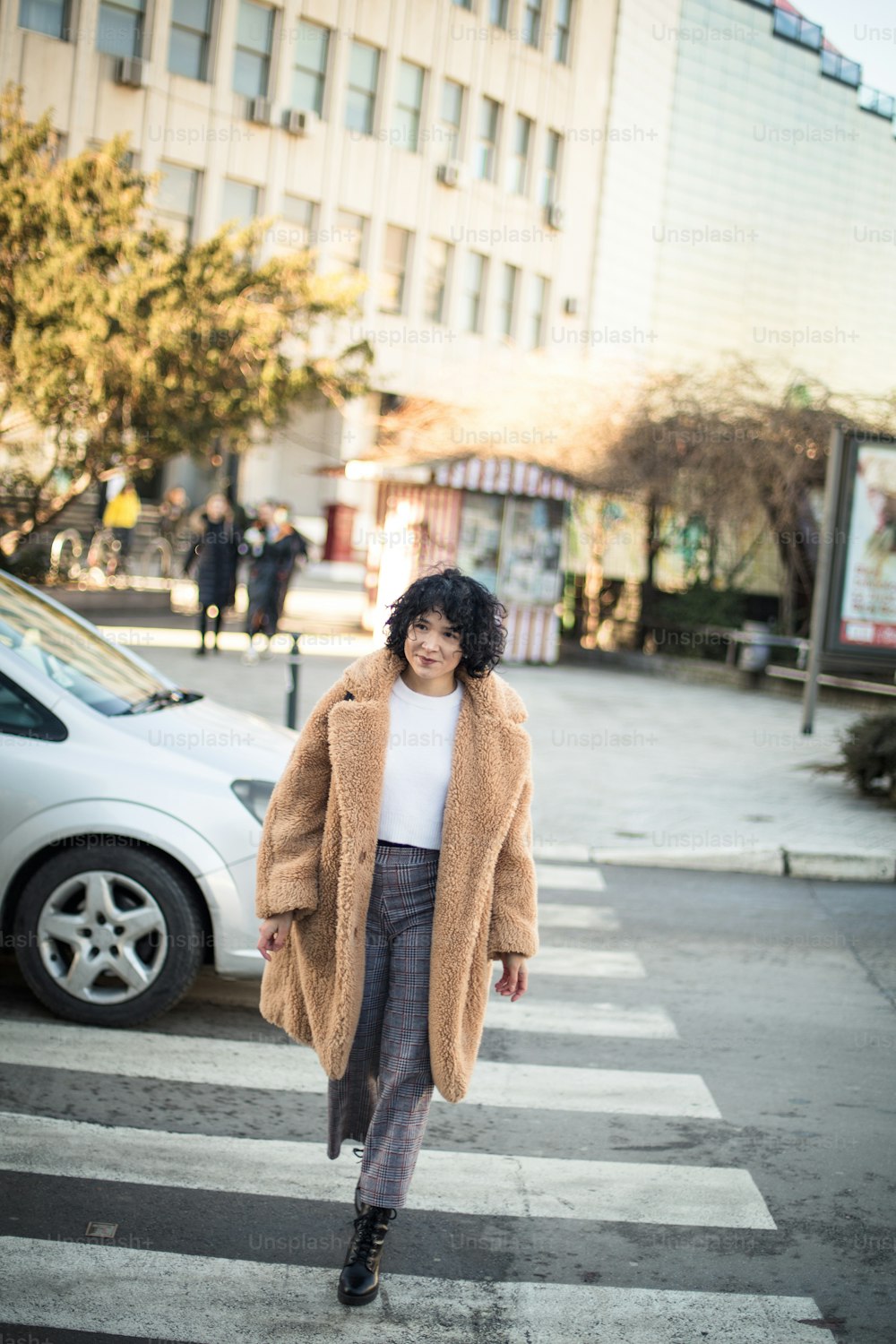 Smiling Woman crossing the road.