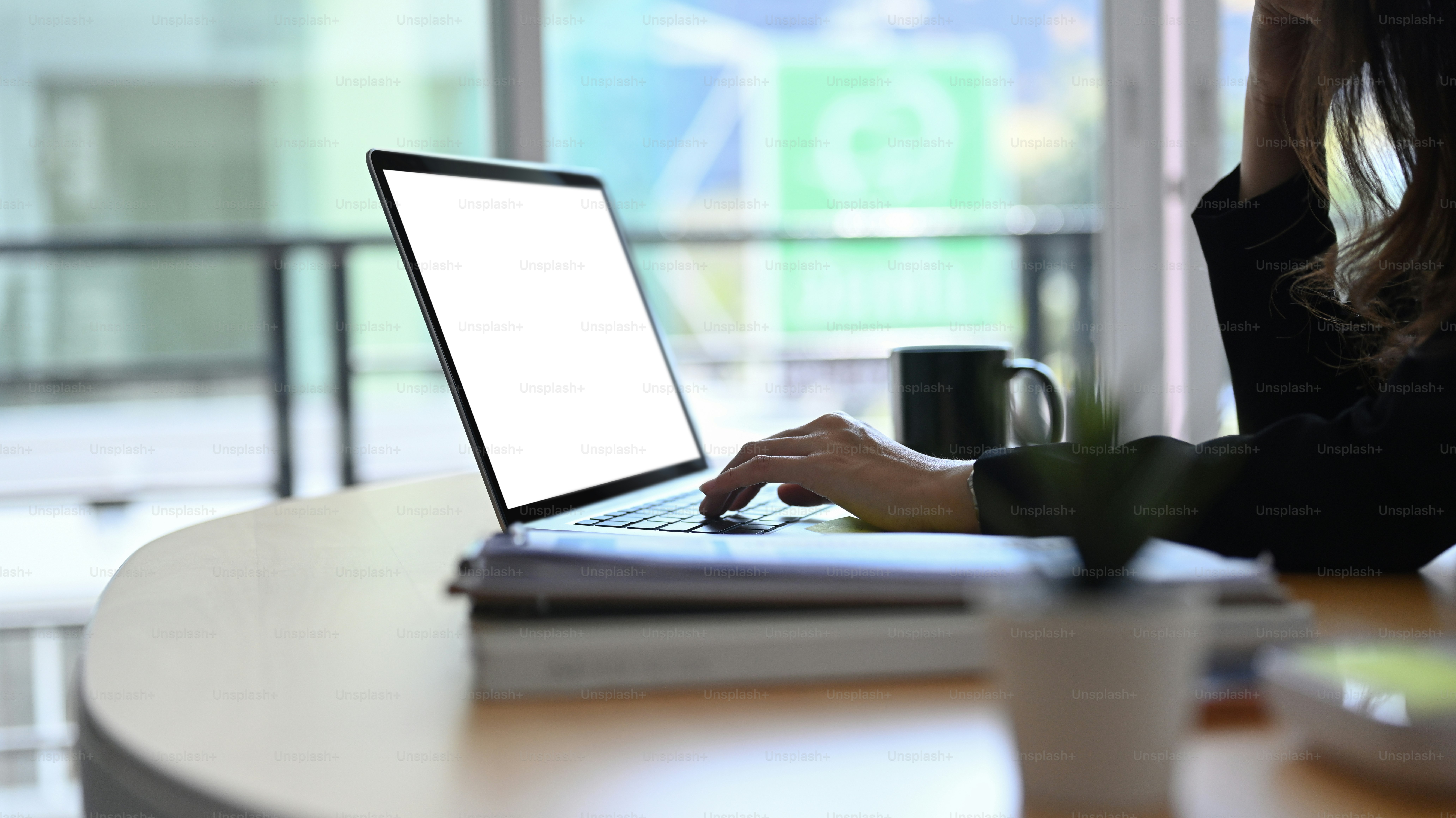 Cropped shot of businesswoman hand typing on computer laptop at her office desk.