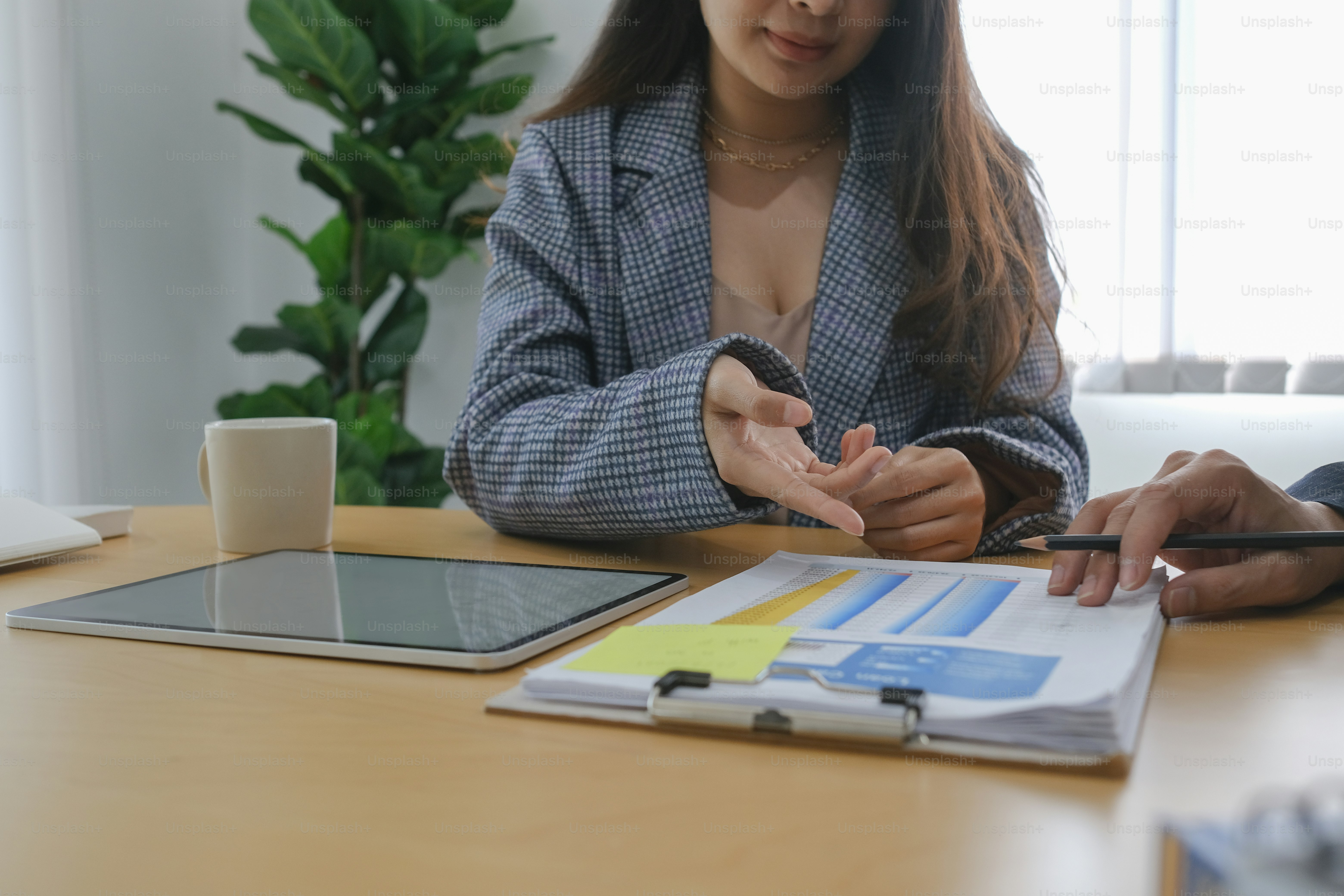 Two business people analyzing and discussing some paperwork.
