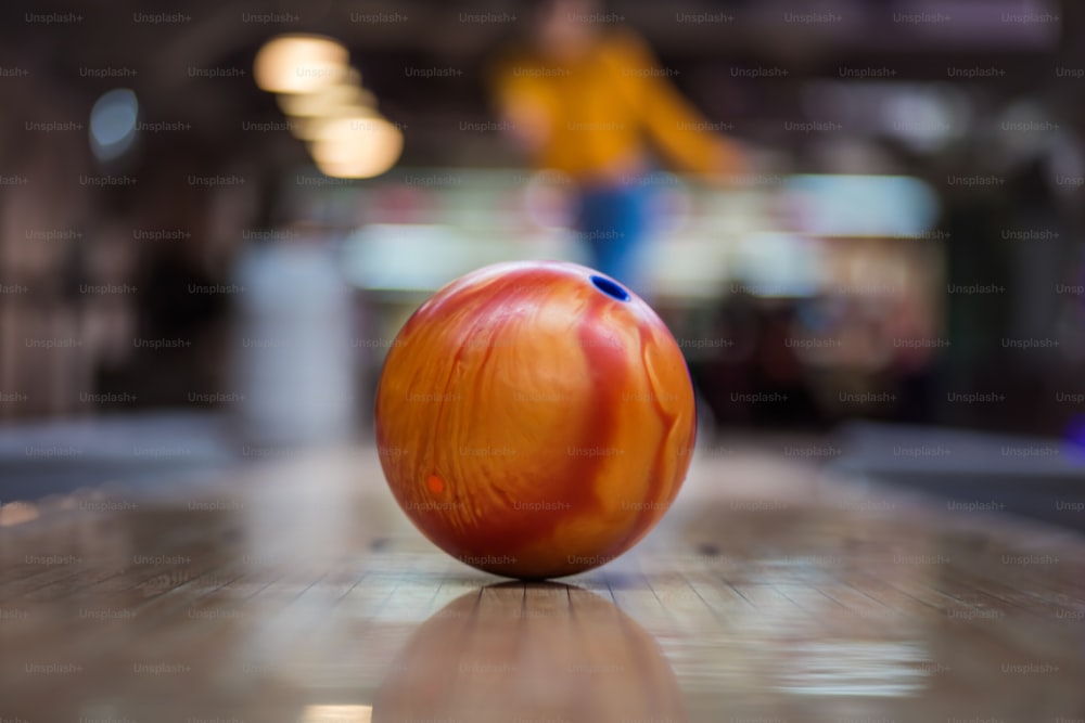 Woman playing bowling game. Focus is on bowler.