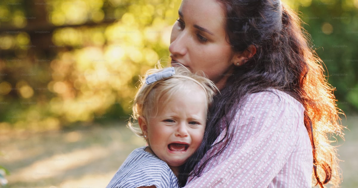 Mother hugging pacifying sad upset crying toddler girl. Family young ...