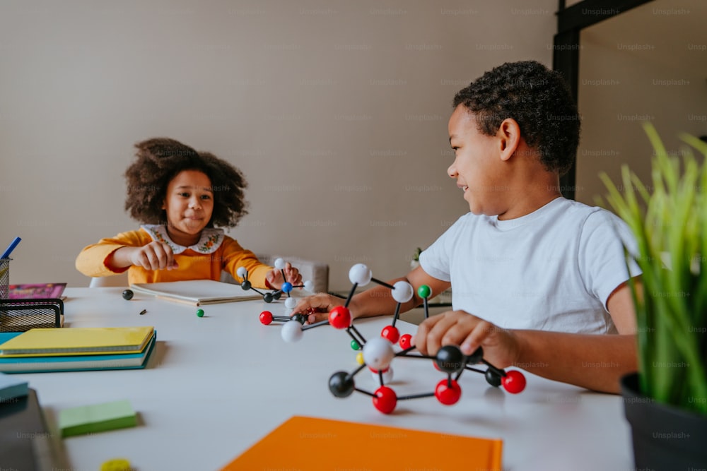 Boy and girl making molecular model lerning chemistry science at home.