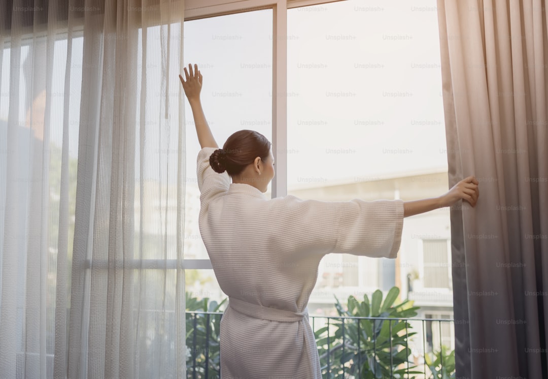 Traveller beautiful asian woman smile to look over there stay near the door in hotel room