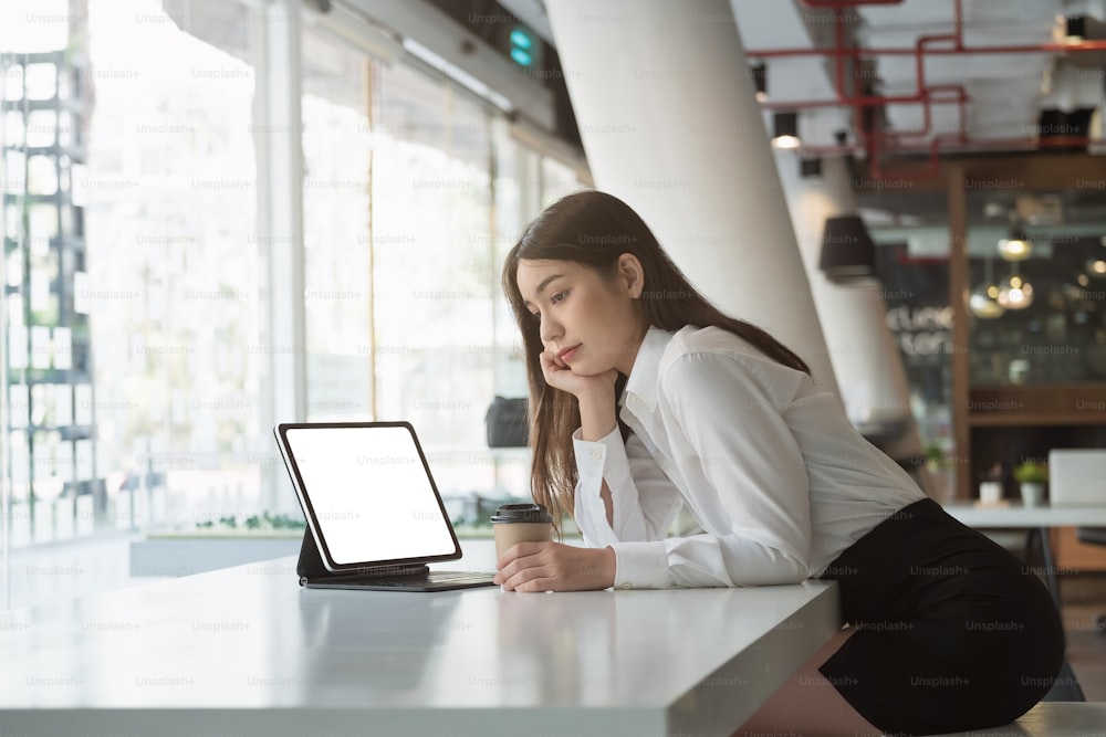 Portrait Of Attractive Asian Business or student using smart tablet blank white screen.