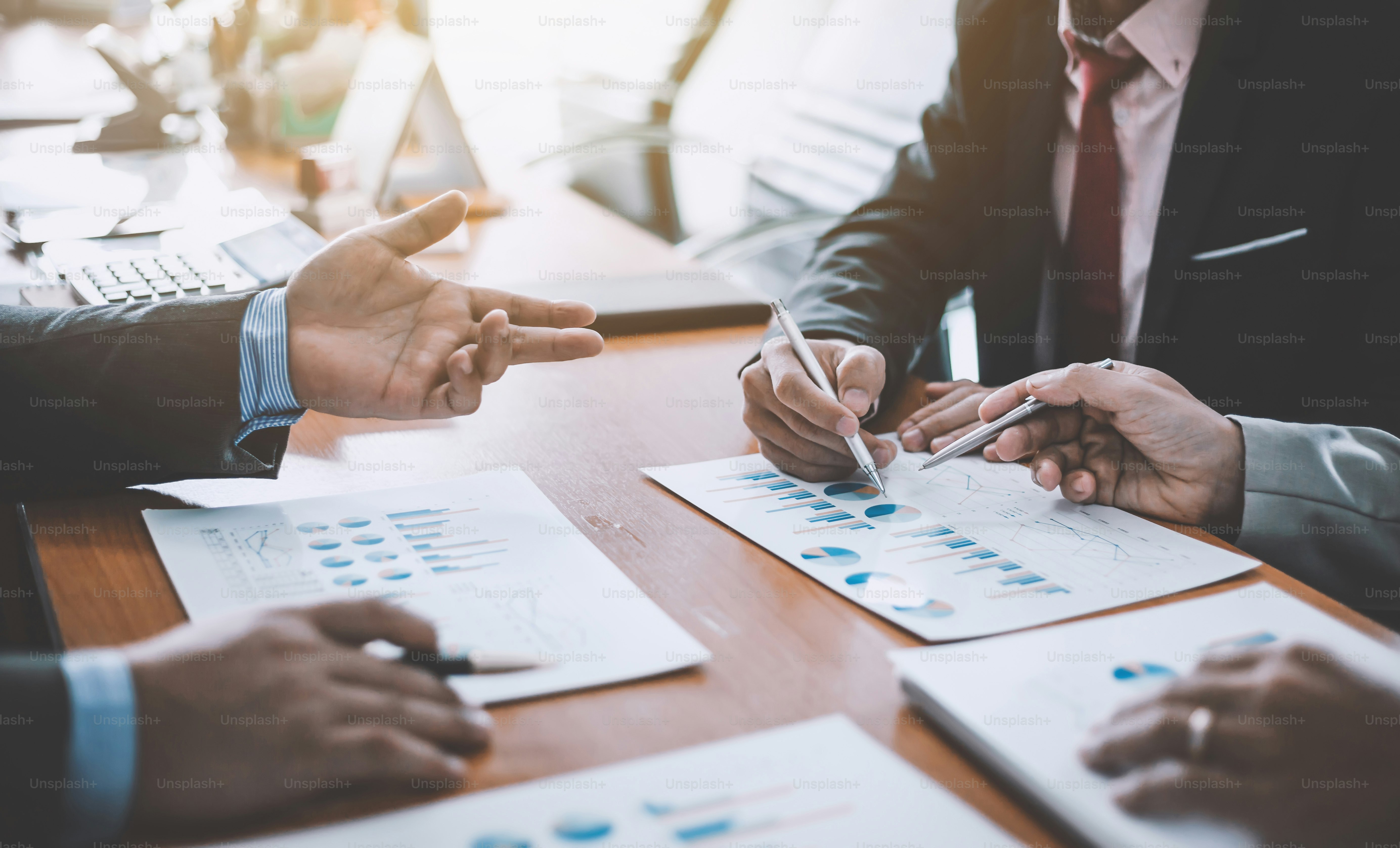 Business people discussion and summary financial information at meeting.