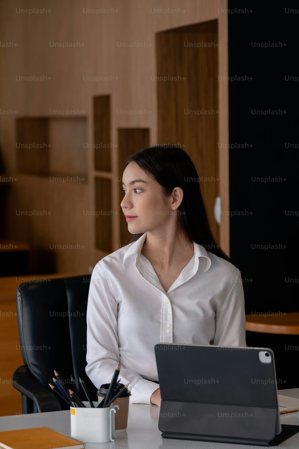 Business woman analysis with business data in tablet computer at her office