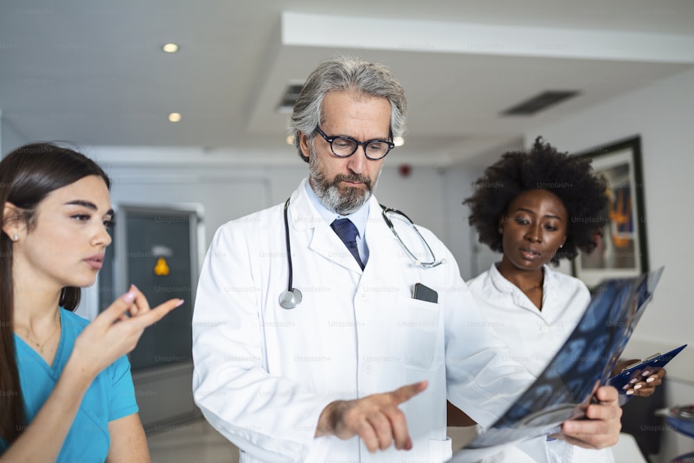 Doctor and surgeon examining xray film, diagnose patient 's CT scan injury. Surgery operation and medical banner design.