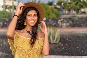 Fashion smiling woman portrait with hat on a head, boho style, hipster girl looking at camera. Summer day.