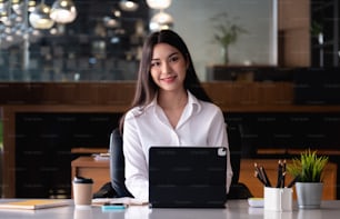 Portrait Of Attractive Asian Businesswoman Working On Laptop at her office