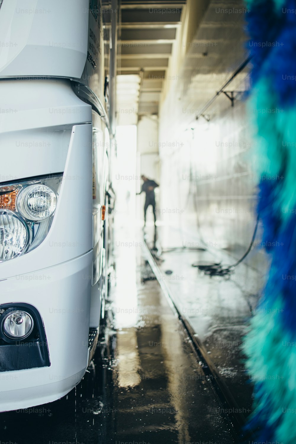 Big truck washing and cleaning at automatic car wash service or station. Transportation concept.