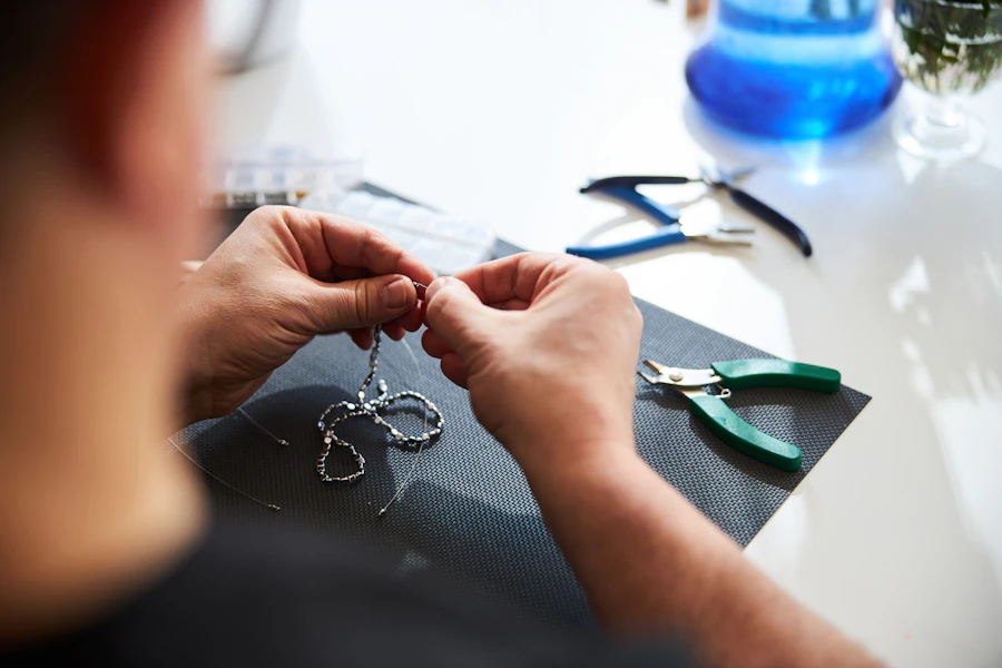 Craftsman shaping a master model at the bench