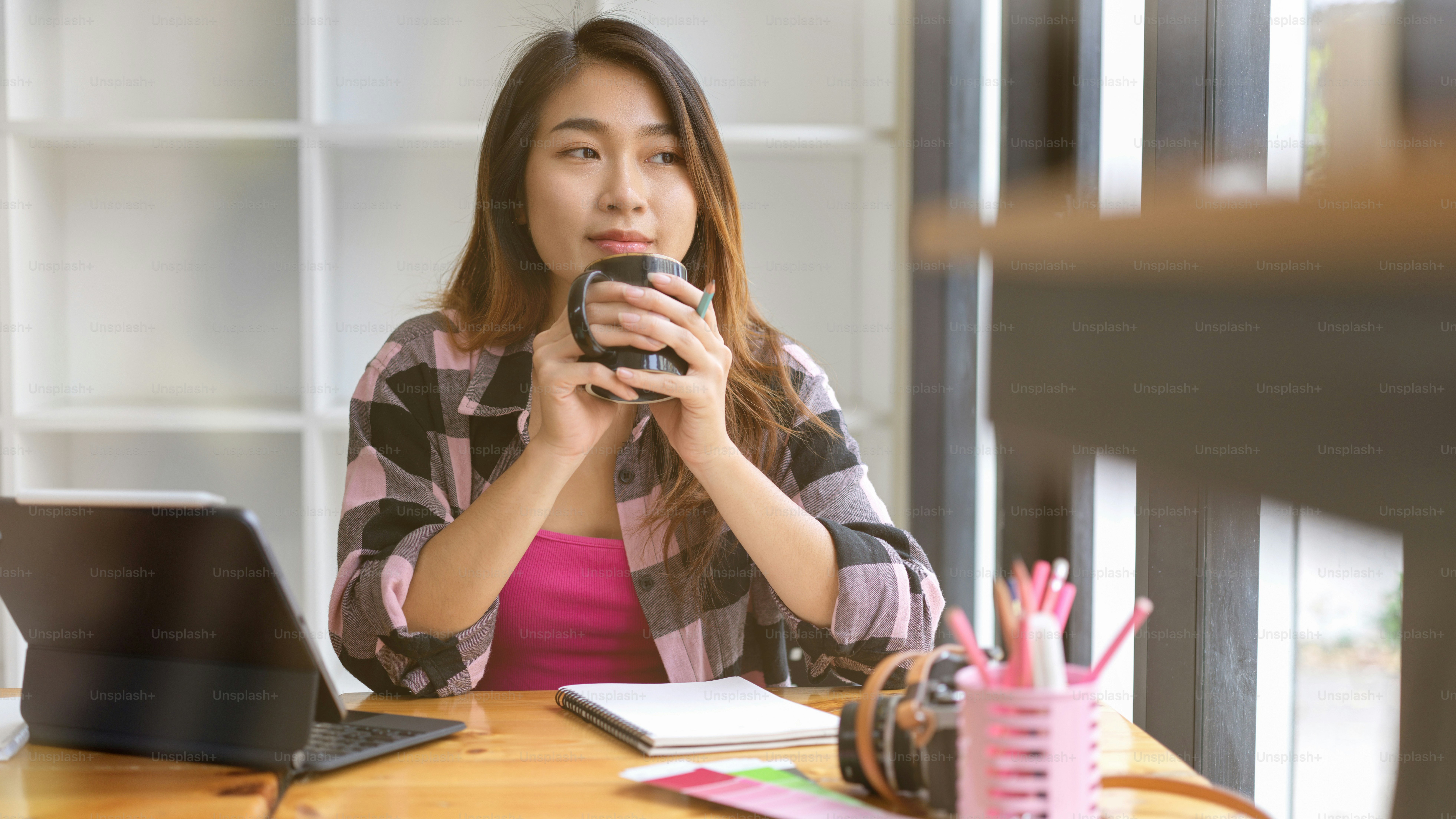 Half-length portrait of young female teenager relaxing with coffee and enjoy the view out of cafe window