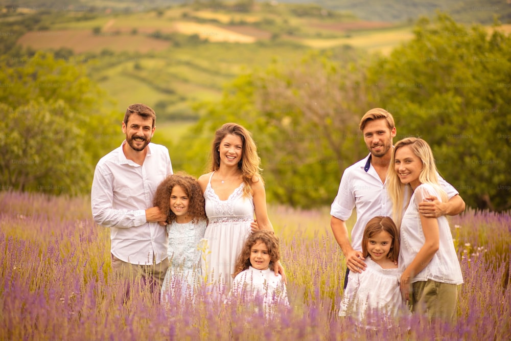 Large group of people in lavender field. Portrait of smiling people.